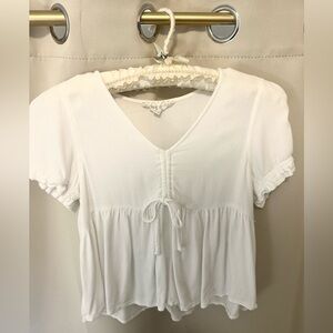 cream baby doll top with front tie and ruffle sleeves